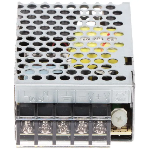 Zdjęcie przedstawia metalowy zasilacz impulsowy z perforowaną obudową, umożliwiającą wentylację. Na przedniej części widoczne są oznaczenia zacisków elektrycznych oraz potencjometr do regulacji napięcia.