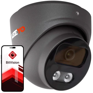 Kamera kopułowa IP w kolorze ciemnoszarym z widocznym obiektywem i diodami LED. Obok kamery znajduje się smartfon z aplikacją BitVision na ekranie.