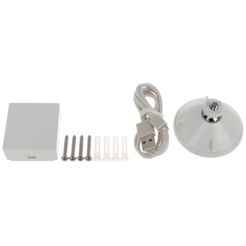 Na zdjęciu znajduje się zestaw montażowy składający się z białego modułu, czterech śrub z kołkami, kabla USB oraz okrągłej podstawki z regulowanym uchwytem. Elementy są ułożone na białym tle, co podkreśla ich kształt i funkcjonalność.