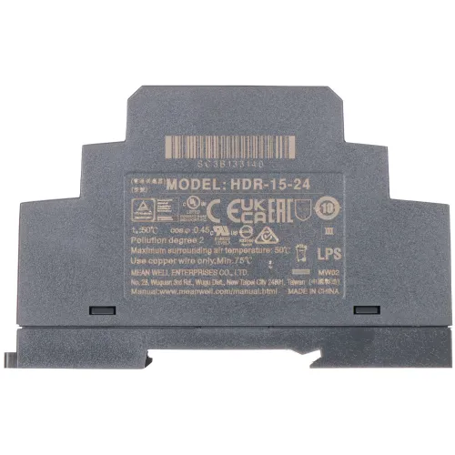 Zdjęcie przedstawia zasilacz impulsowy Mean Well HDR-15-24 z widocznymi oznaczeniami technicznymi i certyfikatami na obudowie. Urządzenie ma szarą obudowę i jest przeznaczone do montażu na szynie DIN.